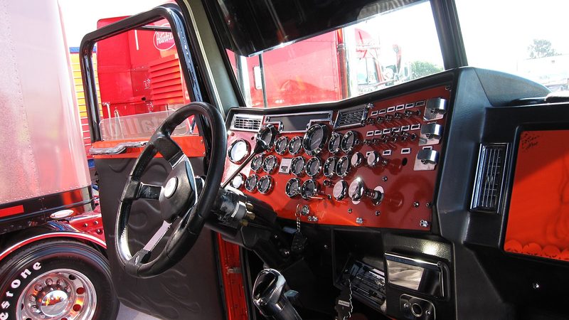 The inside of a Peterbilt, where a fan has to be strapped down rather than perched