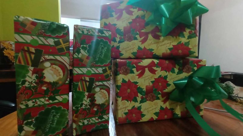 Wrapped gifts on a cloth, a Christmas pile rather than a specific cab product