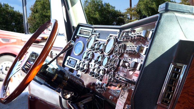 A Freightliner Cascadia dashboard at a Flying J, the panel an inverter has to live beside