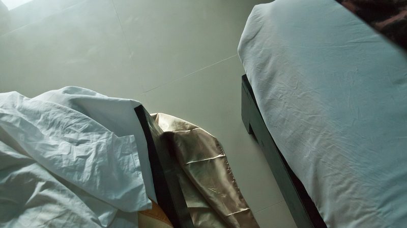 A made bed with white linens, a stand-in for sleep gear rather than a measured truck bunk