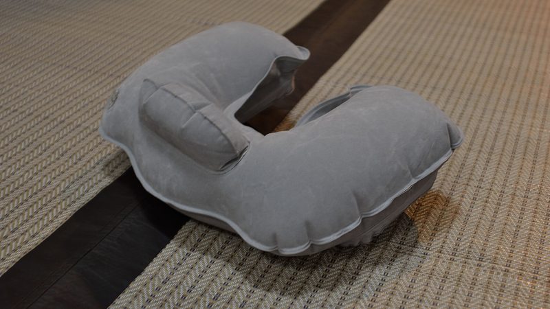 A U-shaped travel pillow on a white background