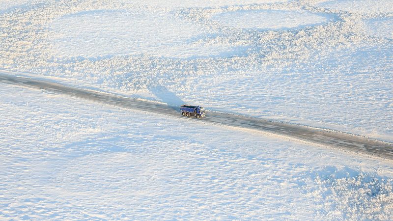 A truck on a winter road, the weather a sleeper has to sleep through